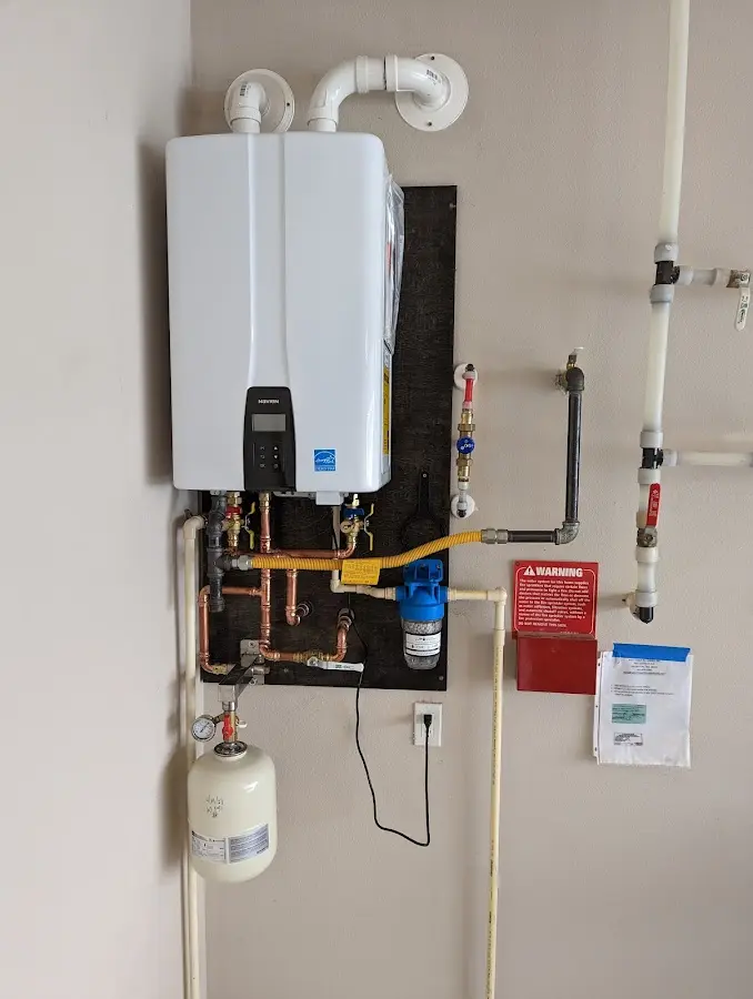 Professional plumber installing copper piping in a Manchester home